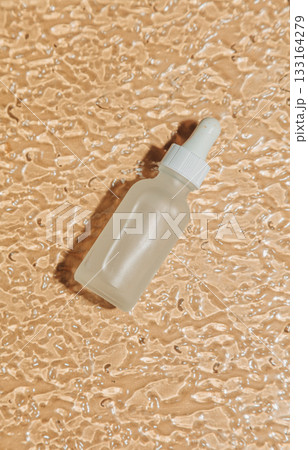 Transparent jar on wavy glass background 133164279