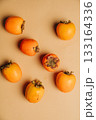 ripe orange persimmon rests elegantly on a beige background 133164336