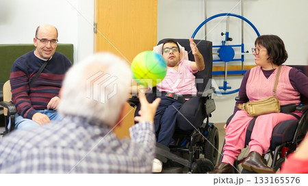 Group of adults with physical disabilities playing ball 133165576