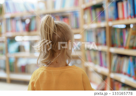 girl looking for books in library girl looking for books in library 133165778