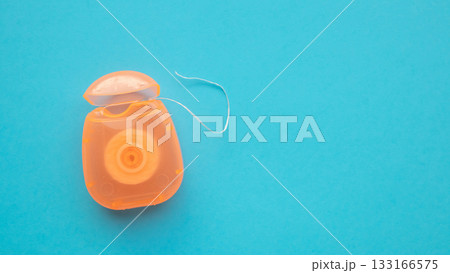 dental floss in case on blue background dental floss in case on blue background 133166575
