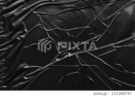 black crumpled and creased plastic poster texture background 133166747