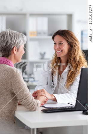 Compassionate doctor comforting patient in consultation Compassionate doctor comforting patient in consultation 133167277