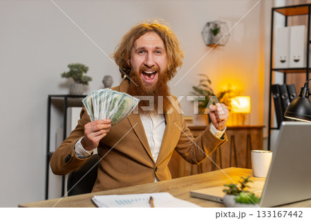 Excited businessman counting cash money dollar checking salary enjoy richness in home office room Excited businessman counting cash money dollar checking salary enjoy richness in home office room 133167442