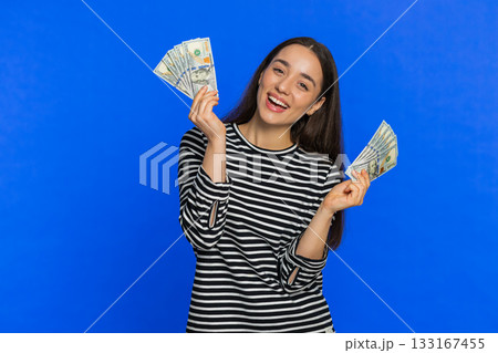 Rich happy woman winner waving money dollar cash like a fan, big income wealth success business 133167455