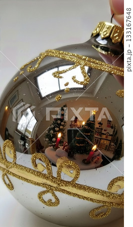 Close Up Detail of Vintage Ornament Reflection with Miniature Christmas Scene and Gold Leaf Accents 133167648