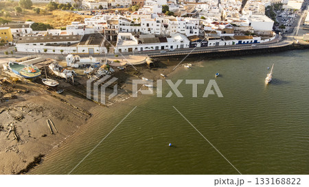 Riverbank with small boats and lots of litter 133168822