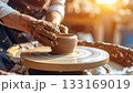 Artisans hands shaping clay on spinning wheel 133169019
