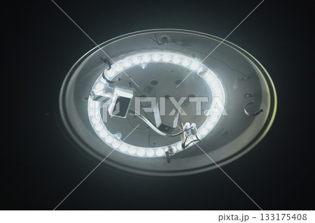 circle white LED lamp flashing on home rooftop 133175408