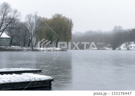 Snow-Covered Floating Docks on a Frozen Lake in Ukraine Snow-Covered Floating Docks on a Frozen Lake in Ukraine 133176447