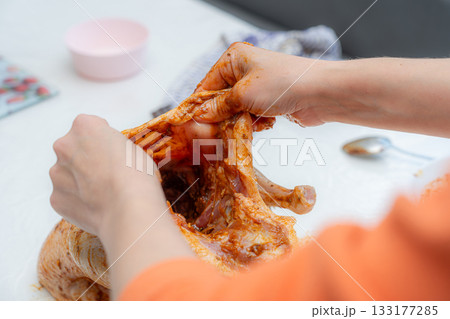 chef cutting meat for cooking 133177285