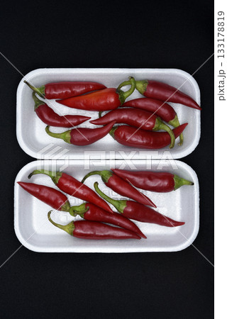 Red capsicum on a plastic backing. Red pepper pods. 133178819