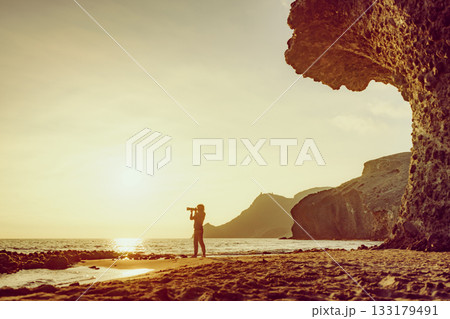 Woman with camera on Monsul beach, Spain Woman with camera on Monsul beach, Spain 133179491