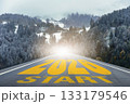 Straight road leading into snowy forest mountains with large text 2026 START. Perfect for business strategy, achievement, planning, and creative projects about new beginnings and opportunities 133179546