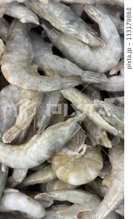 Raw shrimp seafood piled together as a background for culinary or market-related concepts Raw shrimp seafood piled together as a background for culinary or market-related concepts 133179868