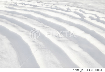 Pattern of curved furrows in the snow full frame 133180061
