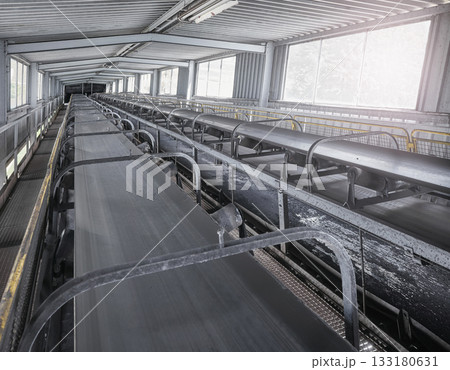 Belt conveyor transporting coal in a heating plant, selective focus. Belt conveyor transporting coal in a heating plant, selective focus. 133180631