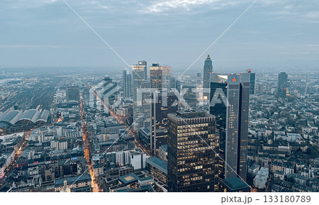 Aerial view of modern city skyline with skyscrapers and urban landscape at dusk Aerial view of modern city skyline with skyscrapers and urban landscape at dusk 133180789