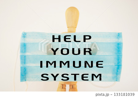 Mannequin is holding a blue face mask with the words Help Your Immune System 133181039