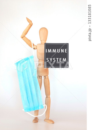 Man holding a blue face mask with the words Immune System written below him Man holding a blue face mask with the words Immune System written below him 133181085