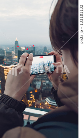 Person capturing city skyline with smartphone at dusk, showcasing urban landscape and technology Person capturing city skyline with smartphone at dusk, showcasing urban landscape and technology 133181132