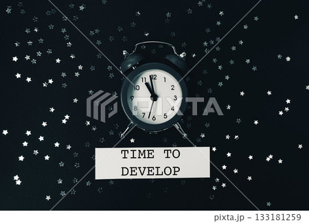 The clock lies on a dark background with glitter and Spitch bubbles. 133181259