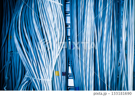bunch of network cables in wave pattern leading across server ro 133181690