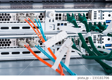 Fiber Optic cables connected to optic ports, network cables conn 133181706