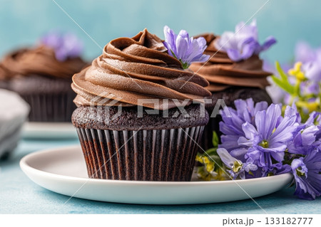 Delicious chocolate cupcakes with flowers on a plate 133182777