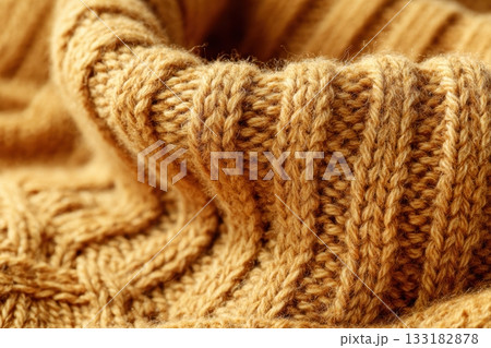 Cozy knitted sweater fabric in warm golden tones 133182878