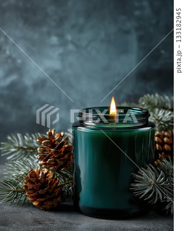 Green candle with pine cones on a dark background Green candle with pine cones on a dark background 133182945