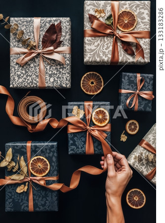 Luxury Gift Wrapping Flat Lay with Artisan Paper Textures, Twine, and Dried Botanicals in Moody Lighting 133183286
