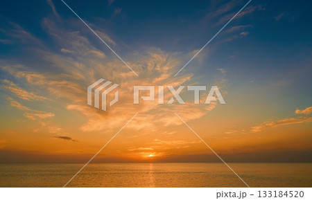 view of the autumn sea and the sunset among beautiful clouds, warm and mild weather of the autumn season at sea, a poster for advertising cosmetics from environmentally friendly natural components view of the autumn sea and the sunset among beautiful clouds, warm and mild weather of the autumn season at sea, a poster for advertising cosmetics from environmentally friendly natural components 133184520
