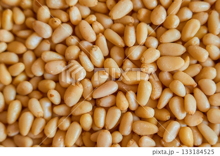 pine nuts, top view of natural healthy products, pine nuts as a super food for health and quality nutrition, poster for advertising nuts pine nuts, top view of natural healthy products, pine nuts as a super food for health and quality nutrition, poster for advertising nuts 133184525