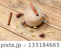 Masala tea in a glass mug with a cinnamon stick. 133184665