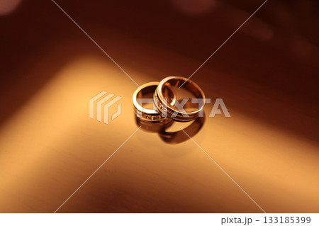 Elegant precious Diamond wedding Rings Resting On Surface With Blurred Backdrop For Wedding ceremony Elegant precious Diamond wedding Rings Resting On Surface With Blurred Backdrop For Wedding ceremony 133185399