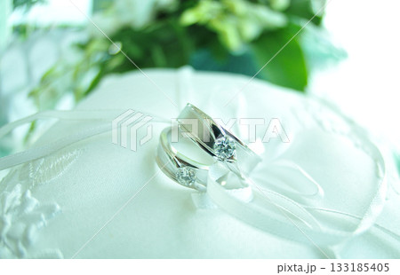 Elegant precious Diamond wedding Rings Resting On Surface With Blurred Backdrop For Wedding ceremony Elegant precious Diamond wedding Rings Resting On Surface With Blurred Backdrop For Wedding ceremony 133185405