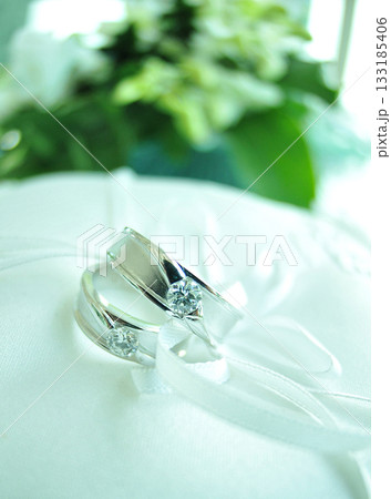 Elegant precious Diamond wedding Rings Resting On Surface With Blurred Backdrop For Wedding ceremony Elegant precious Diamond wedding Rings Resting On Surface With Blurred Backdrop For Wedding ceremony 133185406
