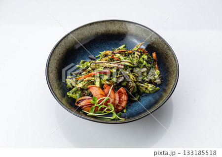 Warm grilled vegetable salad with pesto and balsamic in black bowl, top view Warm grilled vegetable salad with pesto and balsamic in black bowl, top view 133185518