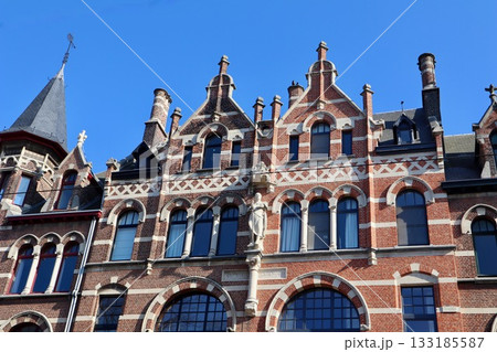 Grand Flemish Neo-Renaissance or Eclectic mansion with red brick facade, intricate arches, and towering turrets in neighborhoods Zurenborg in Antwerp, Belgium 133185587