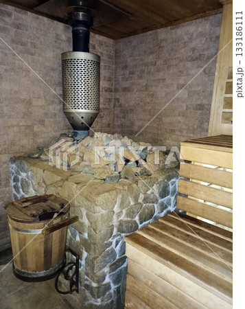 dry sauna, wood trim, steam room with warm lighting. Wooden benches in bathhouse 133186111