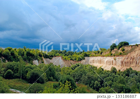 Cretaceous quarry. Landscape with sandy cliffs and thunder storm sky Cretaceous quarry. Landscape with sandy cliffs and thunder storm sky 133186887