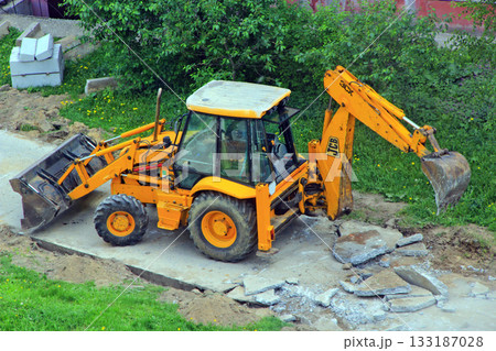 Tractor dismantles old road. Special equipment for road repair at work Tractor dismantles old road. Special equipment for road repair at work 133187028
