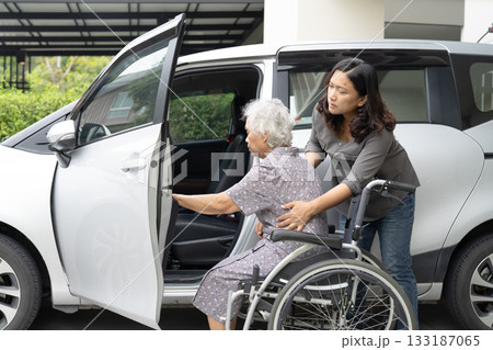 Caregiver help and support asian elderly woman sitting on wheelchair prepare get to her car to travel in holiday. Caregiver help and support asian elderly woman sitting on wheelchair prepare get to her car to travel in holiday. 133187065