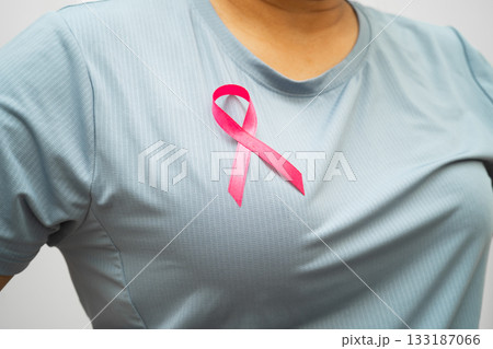 Breast cancer, pink ribbon at Asian senior lady for supporting awareness, symbol of World Breast Cancer Day. 133187066