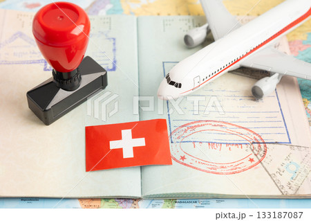 Approved Stamp visa and passport with Switzerland flag document to immigration at airport in country. Approved Stamp visa and passport with Switzerland flag document to immigration at airport in country. 133187087