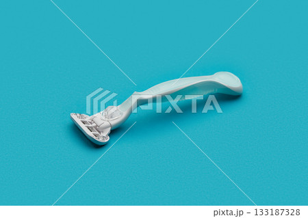 Razor blade on serene blue. Uncomplicated style for a modern touch to your daily routine. Razor blade on serene blue. Uncomplicated style for a modern touch to your daily routine. 133187328