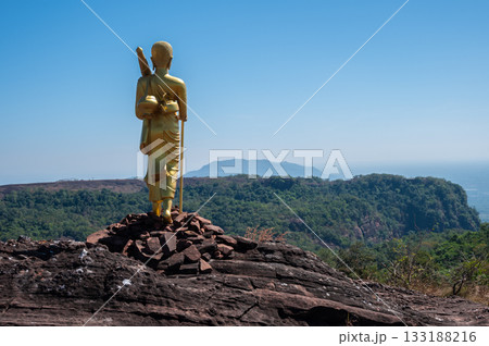 The Buddhist monk statue situated on Phu Langka mountain in Bueng Kan province of Thailand. This site is a prime viewpoint to watch the sunrise and landscape as far as Laos. The Buddhist monk statue situated on Phu Langka mountain in Bueng Kan province of Thailand. This site is a prime viewpoint to watch the sunrise and landscape as far as Laos. 133188216