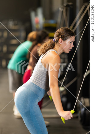 Woman doing exercises on ski ergometer simulator 133188340
