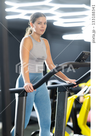 Young woman doing cardio exercises on treadmill 133188341